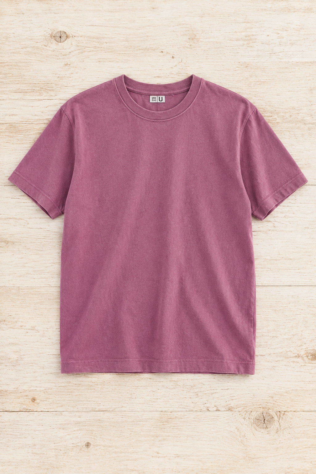 Detalle del cuello y tejido de una camiseta Uniqlo rosa malva de algodón